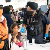 A Border Force worker processes refugees from Afghanistan in London 