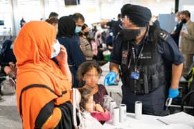 A Border Force worker processes refugees from Afghanistan in London 