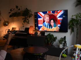 A woman watches an episode of the newly released Netflix docuseries "Harry and Meghan" about Britain's Prince Harry, Duke of Sussex, and Britain's Meghan, Duchess of Sussex, in London. Picture: Daniel Leal/AFP via Getty Images
