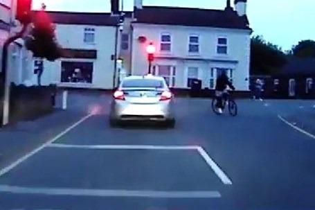 Shocking moment driver narrowly misses cyclist before swerving violently towards shops during police chase