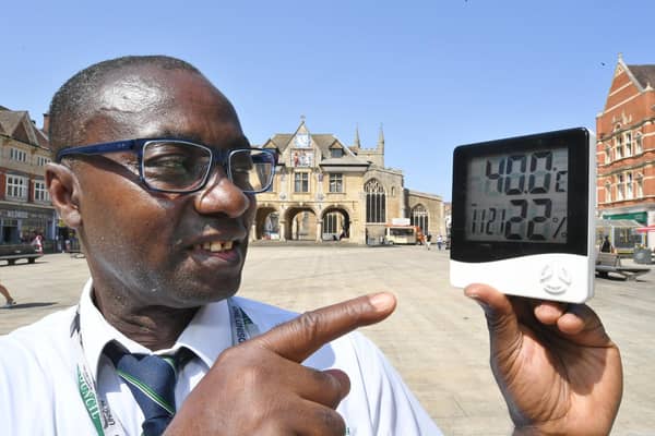 Ernest Mensah-Sekyere with a digital thermometer reading 40 degrees in direct sunlight at Cathedral Square - however, the Met Office's official readings did not reach 40C at their nearest weather station to Peterborough.